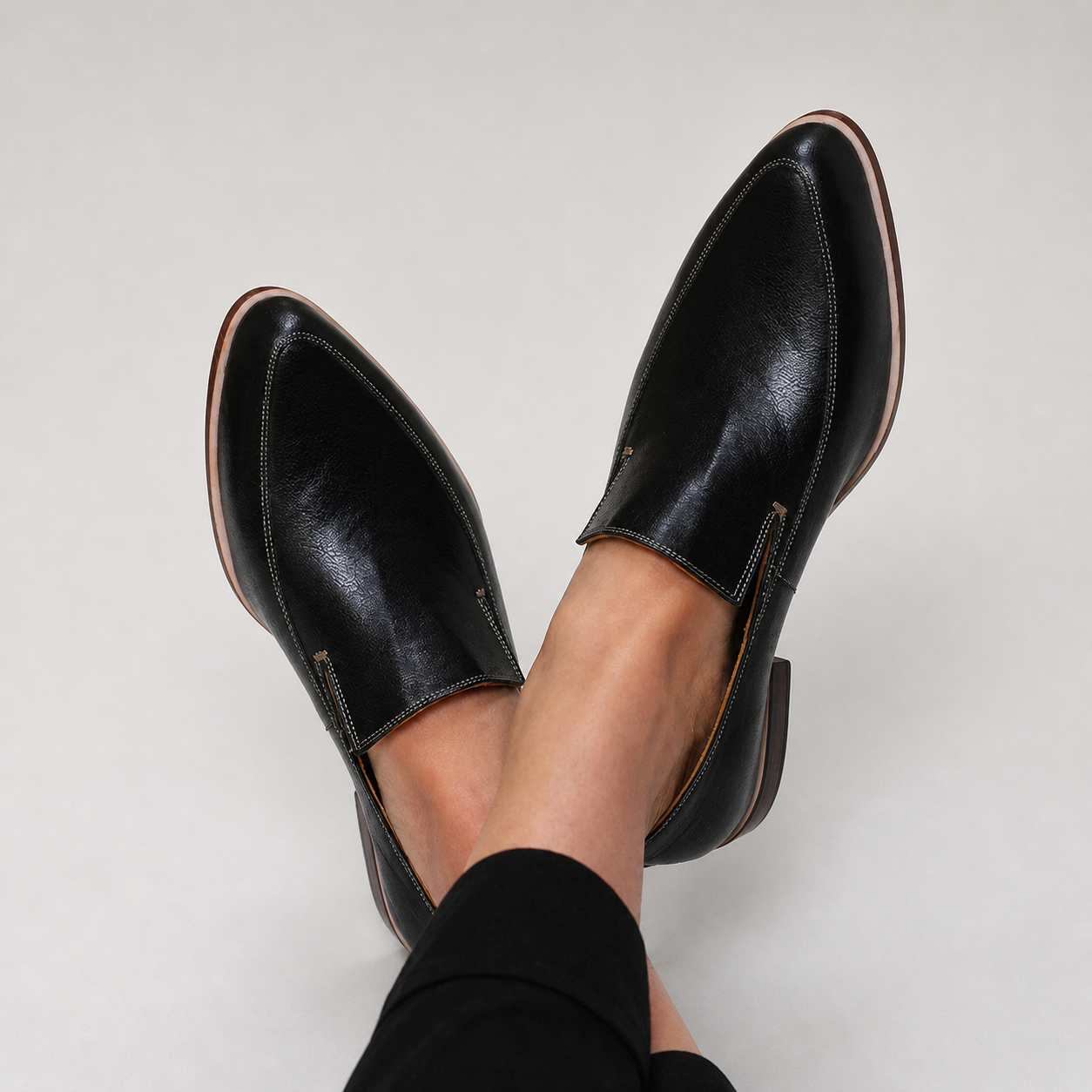 Black patchwork loafers with a structured design and subtle finish