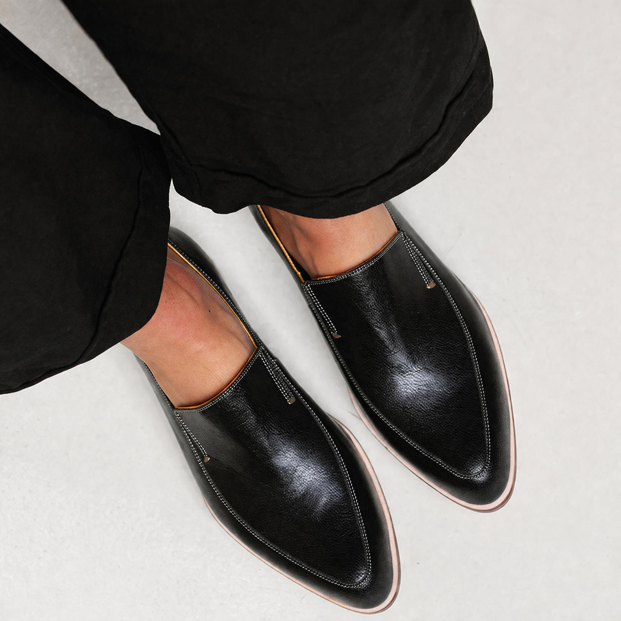 Black patchwork loafers with a structured design and subtle finish